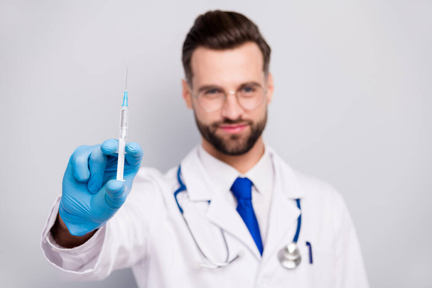 Close-up blurred portrait of his he nice attractive experienced qualified bearded doc paramedic preparing showing prick drug anti virus isolated on light white gray pastel color background - Fotoğraf, Görsel