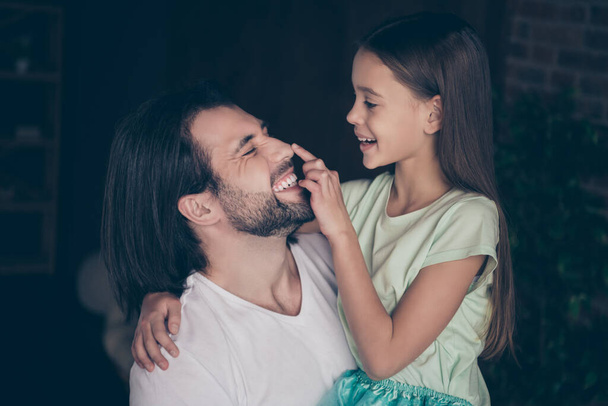 Closeup photo of pretty little adorable lady her handsome young daddy hugging smiling touch nose finger spend weekend time homey domestic atmosphere house room indoors - Foto, afbeelding