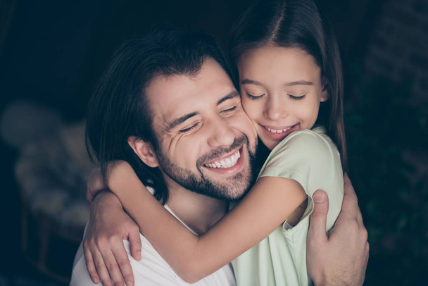 Closeup photo of beautiful little adorable lady her handsome young daddy hugging dreamy smiling eyes closed spend weekend time homey domestic atmosphere house room indoors - Foto, imagen
