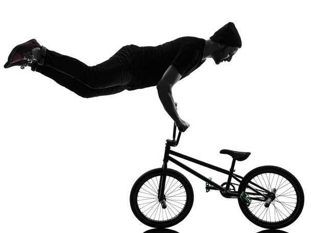 one caucasian man exercising bmx acrobatic figure in silhouette studio isolated on white background - Fotoğraf, Görsel