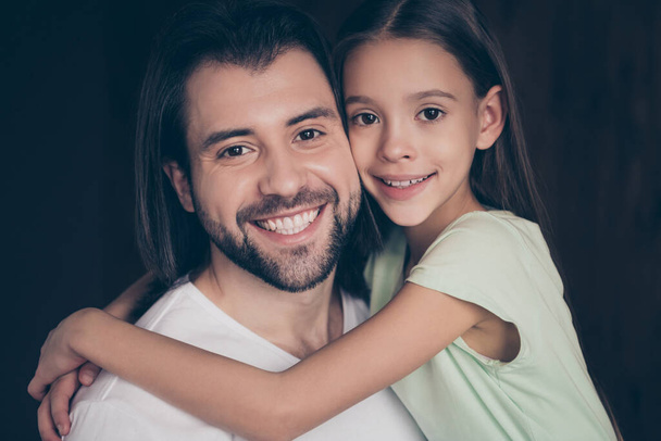 Closeup photo of beautiful little adorable lady and her handsome young daddy hugging dreamy toothy smiling spend weekend time homey domestic house room indoors - Φωτογραφία, εικόνα