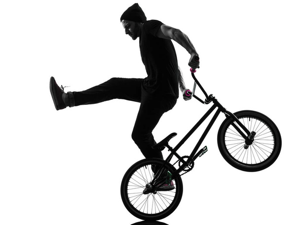 one caucasian man exercising bmx acrobatic figure in silhouette studio isolated on white background - Fotoğraf, Görsel