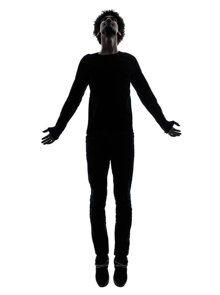 one african handsome young man jumping   in silhouette studio isolated on white background - Φωτογραφία, εικόνα