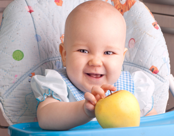 Baby with yellow apple - Foto, imagen