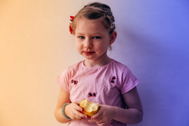 portrait of a little girl eating apple  - Photo, Image