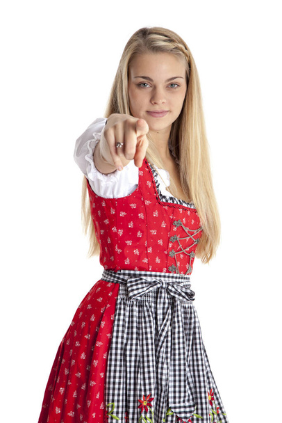 woman in dirndl pointing with her finger. - Foto, afbeelding