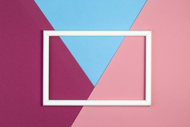 Multicolored paper with empty picture frame. flat layout with copy space. - Foto, afbeelding
