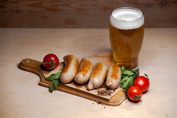 Fried sausages with a glass of light beer - Zdjęcie, obraz