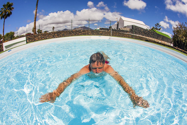 smart man enjoys swimming in the pool - Valokuva, kuva