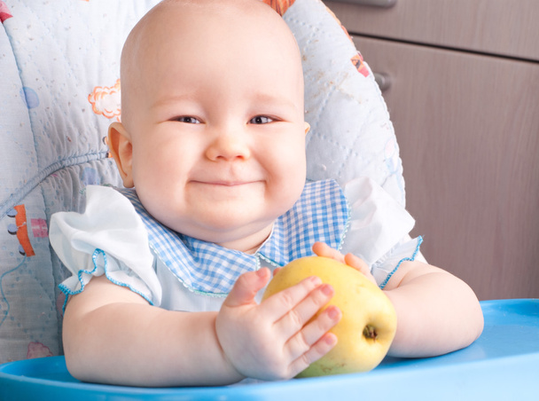 Baby with yellow apple - Фото, зображення