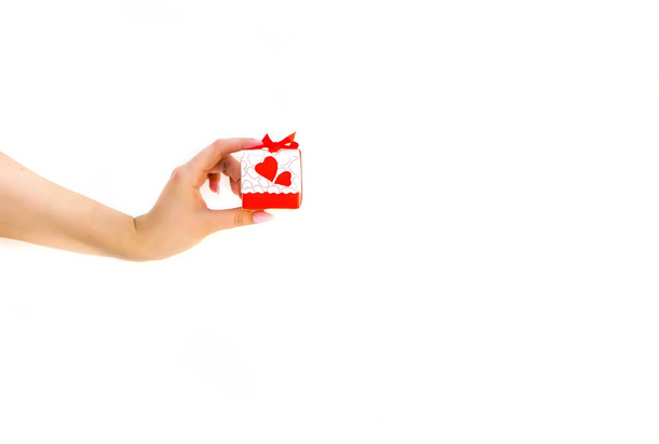 small cute gift box in a woman's hand on a white background, Val - Фото, изображение