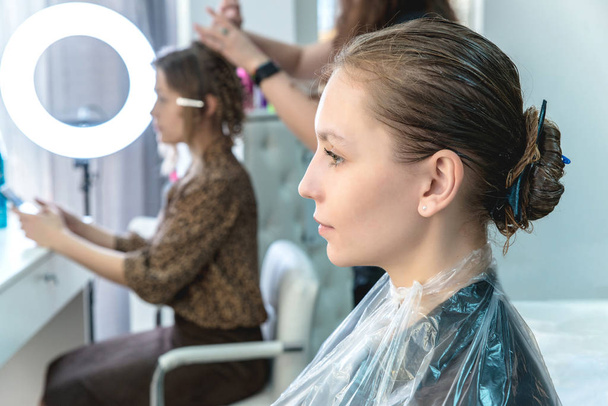 hair coloring in a beauty salon, young girl during dyeing process - Photo, Image