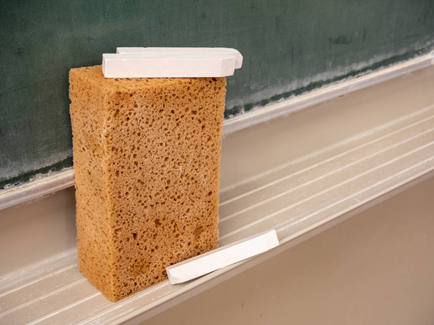 Blackboard sponge with chalk in the classroom - Photo, Image