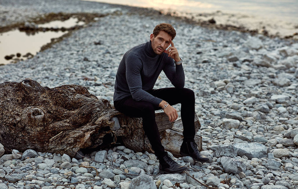 Fashionable male model wear turtleneck and posing outdoor near t - Фото, изображение