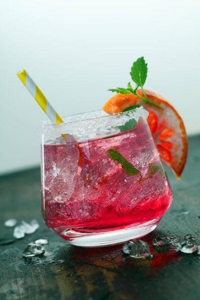 Beautiful close-up of a glass of chilled pink color cocktail. - Фото, изображение