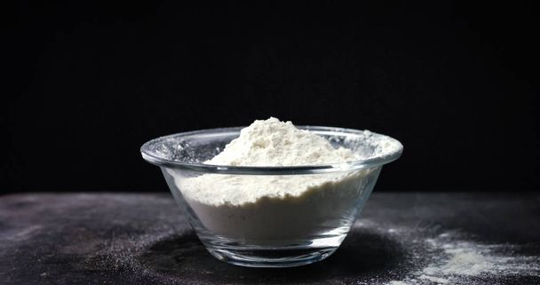 Flour falling on black background - Fotó, kép