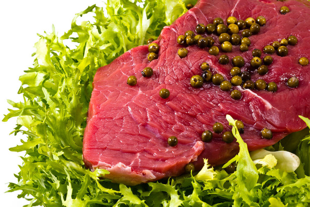 Closeup of raw beef decorated with some green pepper grains - Fotoğraf, Görsel