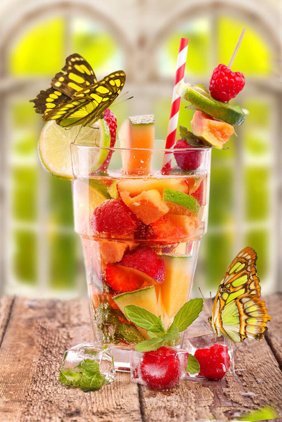 fresh fruit cocktail at the window with butterflies - Zdjęcie, obraz