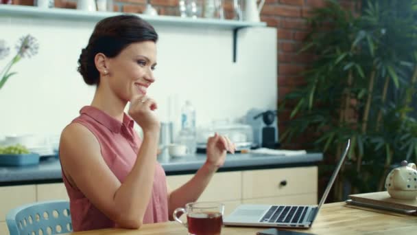 Business woman finishing work on laptop. Young girl drinking tea at home. - Materiaali, video