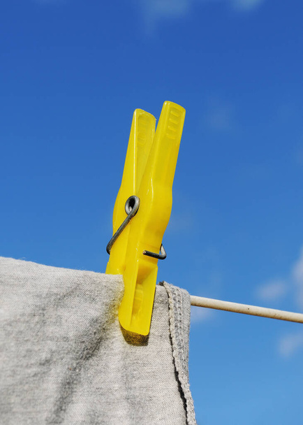clothespin with t-shirt,clothesline and blue sky - 写真・画像