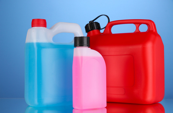 Liquids for car in canisters on blue background - Foto, Imagem