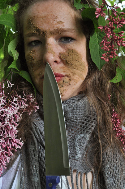 Closeup of woman in green bush  - Фото, изображение