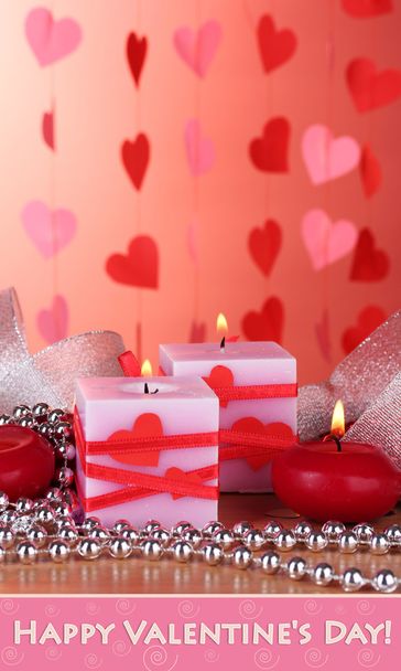 Candles for Valentine Day on wooden table on red background - Fotoğraf, Görsel