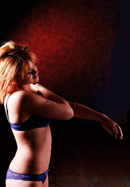 Sensual blonde girl in underwear on dark background, - Foto, afbeelding
