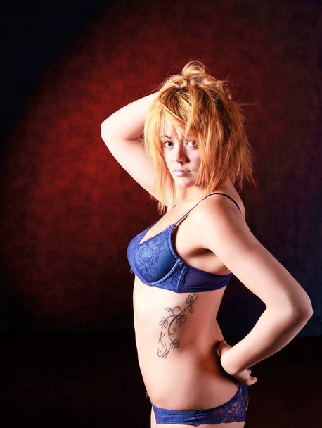 Sensual blonde girl in underwear on dark background, - Фото, изображение