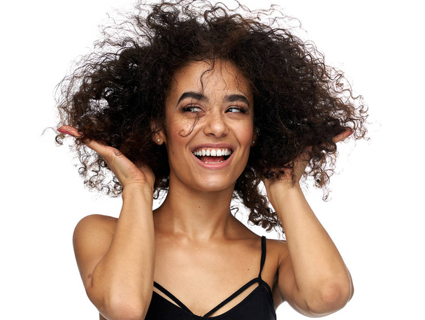 Funny latin american woman playing with her afro hairstyle isola - Photo, image