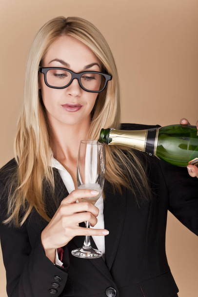 A businesswomen woman holding a glass of champagne at a party. - Foto, imagen
