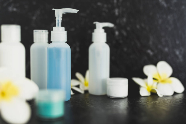 lotions and moisturizer bottles on black marble shot at shallow  - 写真・画像