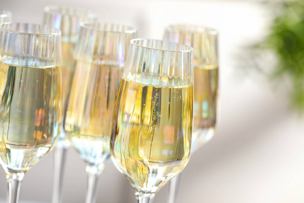 Glasses of champagne on blurred background, closeup view - Фото, изображение