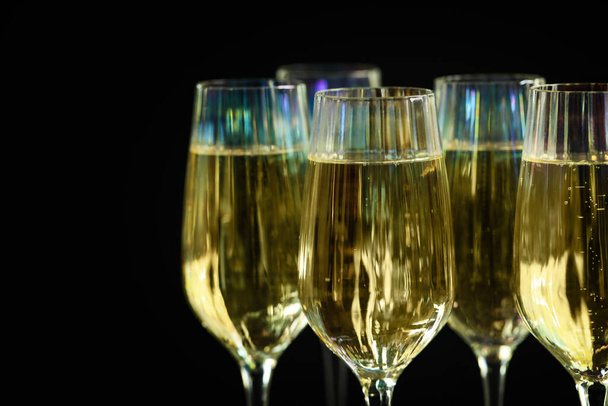 Glasses of champagne on black background, closeup - Photo, Image