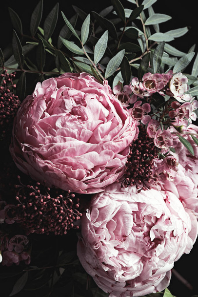 Bouquet of beautiful flowers on black background. Floral card design with dark vintage effect - Foto, imagen
