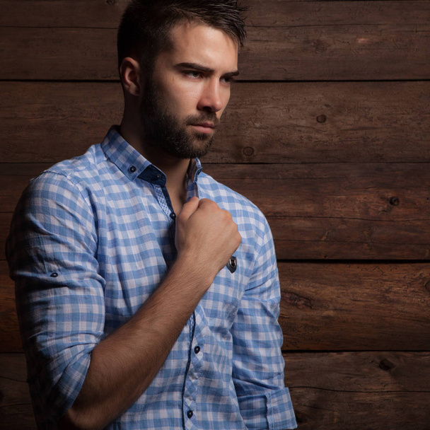 Portrait of handsome young man on wooden background. - 写真・画像