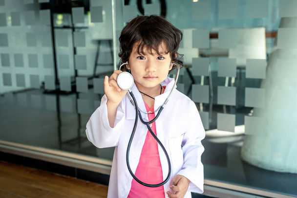 Фото детского врача со стетоскопом, работающего в офисе
 - Фото, изображение