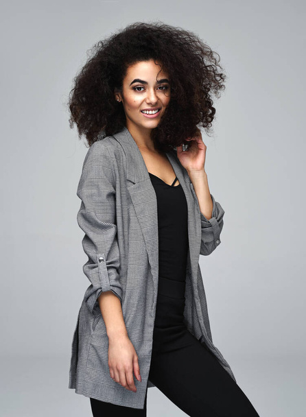 Beautiful cheerful latin american woman wear gray jacket isolate - Foto, imagen