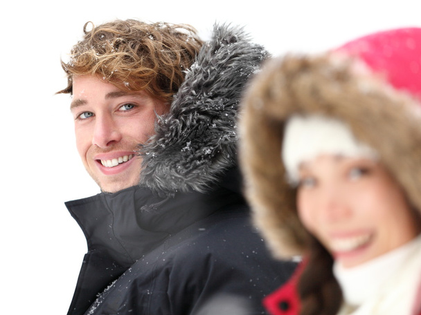 Outdoor couple smiling in winter snow - Fotografie, Obrázek
