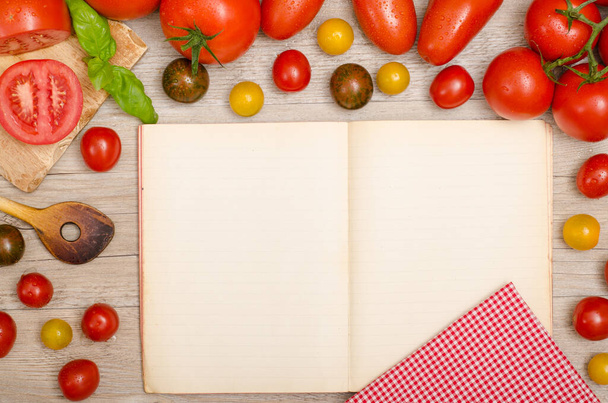 various types of tomatoes,basil,cooking spoon,napkin and cover with copy space - 写真・画像