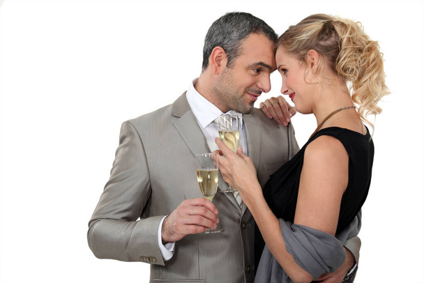 Couple dancing with glasses of champagne - Фото, изображение