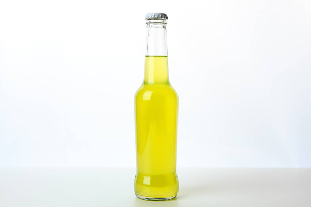 glass bottle with orange juice, white background - Photo, image