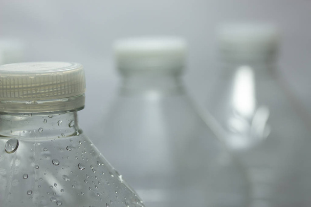 empty bottles of water on a dark background - Φωτογραφία, εικόνα