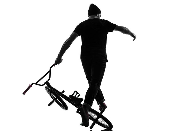 one caucasian man exercising bmx acrobatic figure in silhouette studio isolated on white background - Foto, immagini