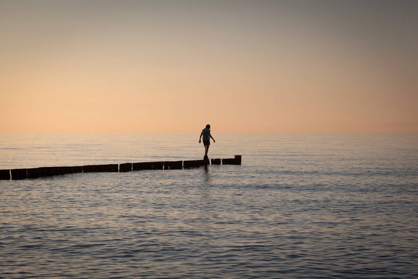 a woman on her way through the sea has almost reached her goal - Fotoğraf, Görsel