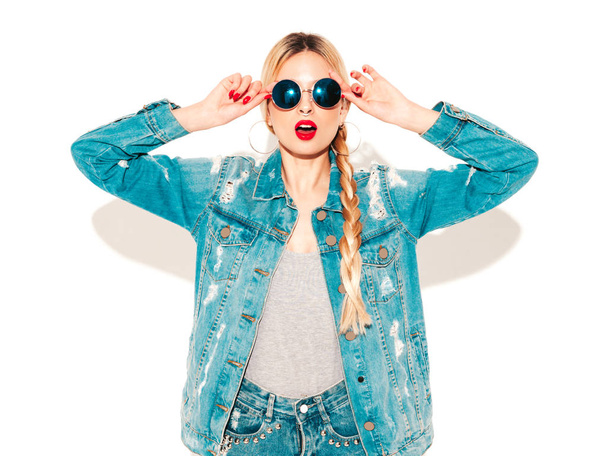 Portrait of young beautiful hipster bad girl in trendy jeans summer clothes and earring in her nose.Sexy carefree smiling blond woman posing in studio.Positive model having fun.Isolated on white - Φωτογραφία, εικόνα