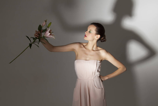woman with a lily flower - Fotoğraf, Görsel