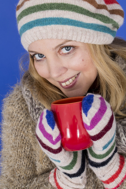 Attractive Young Woman Wearing Woolen Hat Drinking Tea - Photo, image