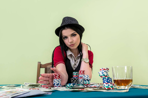 Brunette lady going to make a bet in casino - 写真・画像