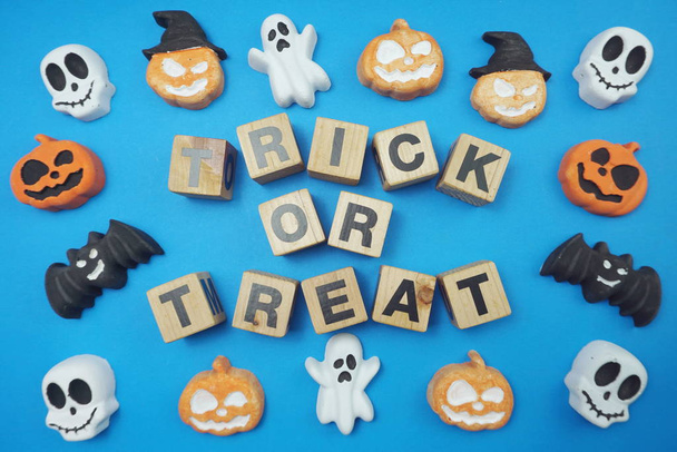 Trick or treat alphabet letters top view on blue background - Foto, afbeelding